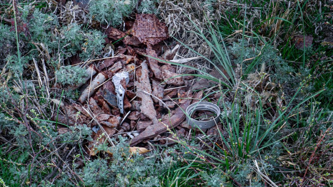 Vestiges d'un engin explosif dans l'herbe.