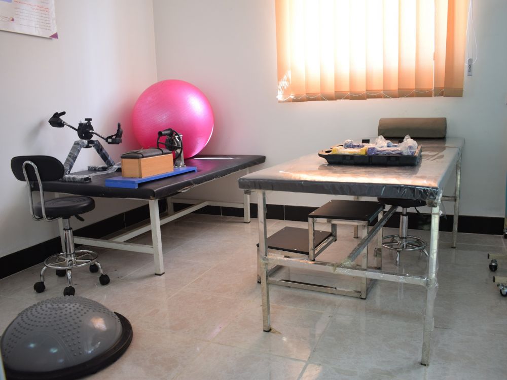 Een nieuw uitgeruste fysiotherapieruimte met fysiotherapietafels, gymnastiekballen, enz.