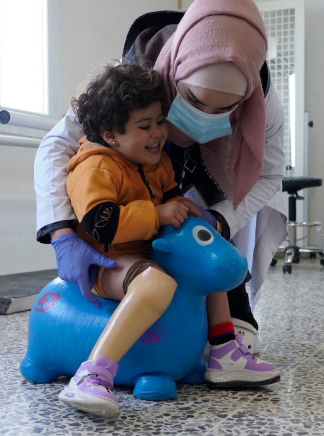 kid with her prosthetist